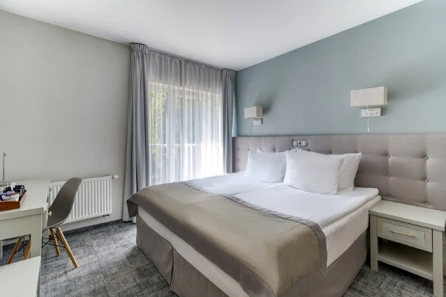 Akademia efektywnej komunikacji zespołowej 2026 w Sopocie – pokój z dużym łóżkiem i biurkiem w Hotelu Aqua